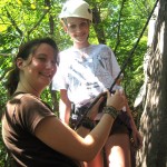 Lexie helping a camper to climb