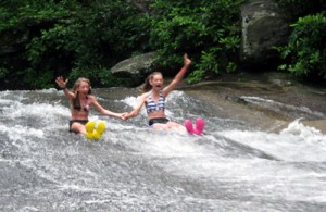 Summer Campers Sliding Down the Rock
