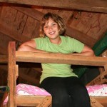 girl camper on her camp bunk bed