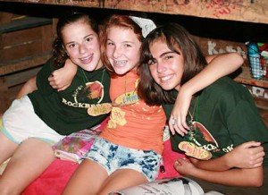 Campers friends on camp cabin bunk