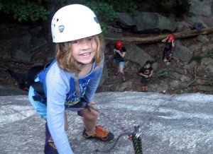 Rock climbing girl at summer camp