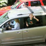 camper departs summer camp waving