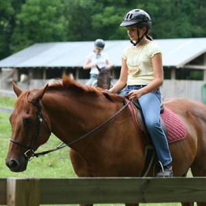Camp girl riding horse back