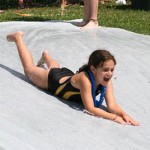 Campers slip an slide down the hill