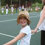 Child enjoying a square dance with neighboring camp