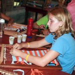 Camp girls weaving on hand loom
