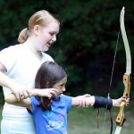 girl summer camp archery teaching