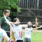 Kids shooting archery at summer camps