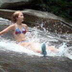 Camper kids sliding down the rock
