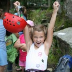 child rock climber at summer camp