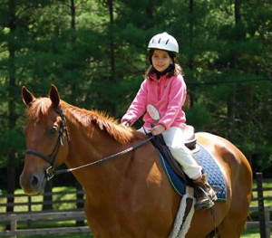Camp girl horseback riding