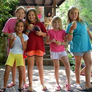 Girls being campers by eating muffins